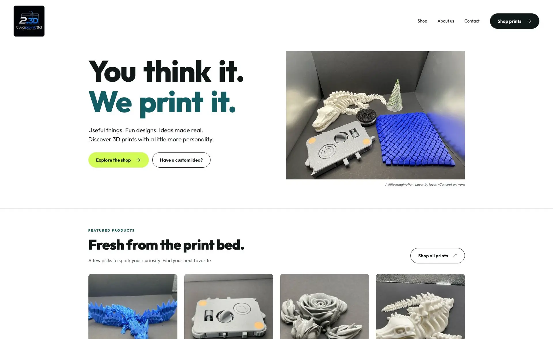 Above-the-fold screenshot of the Two Point 3D homepage with its logo, shop navigation, and featured product imagery